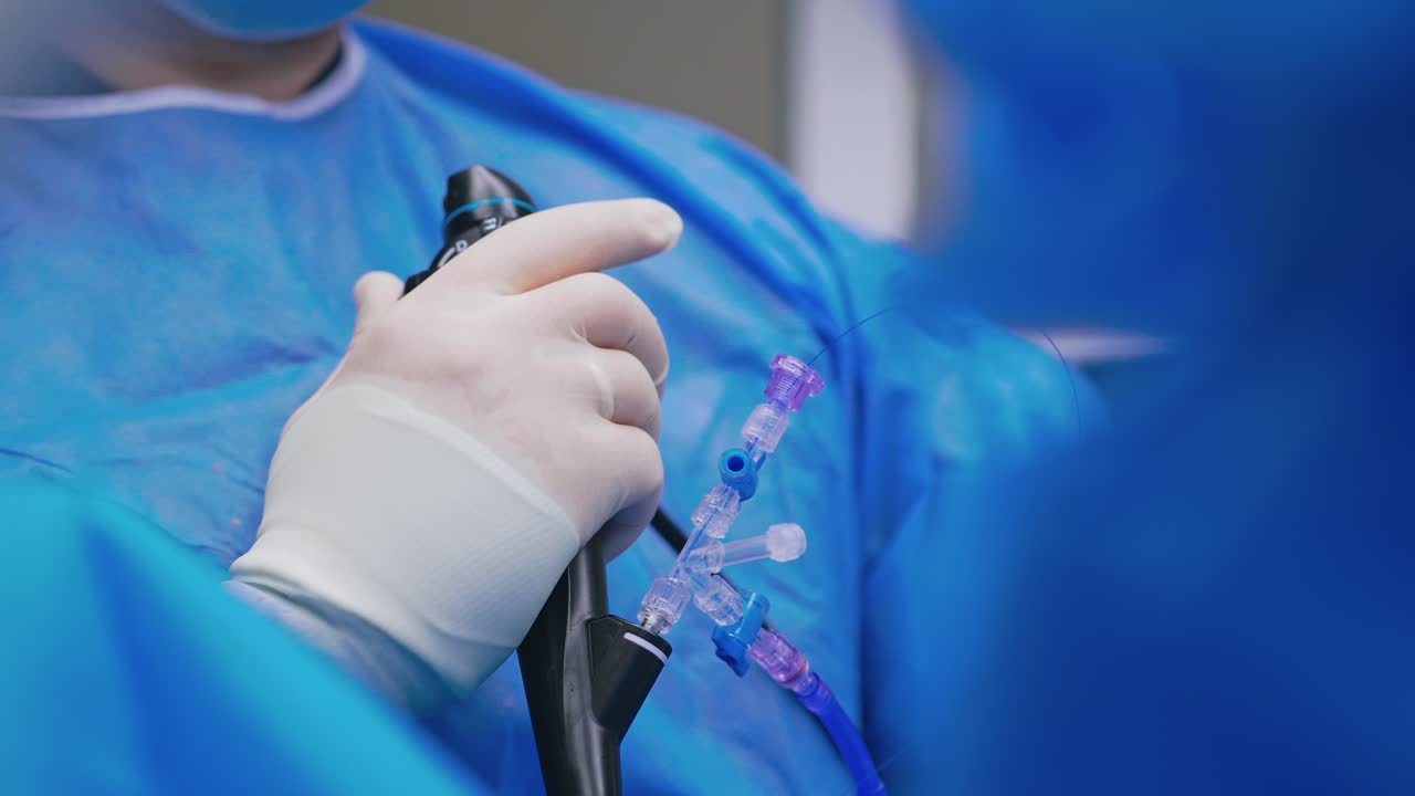Doctor uses special instrument during operation. Surgeon monitoring patient with new equipment in the operating room. Close-up.