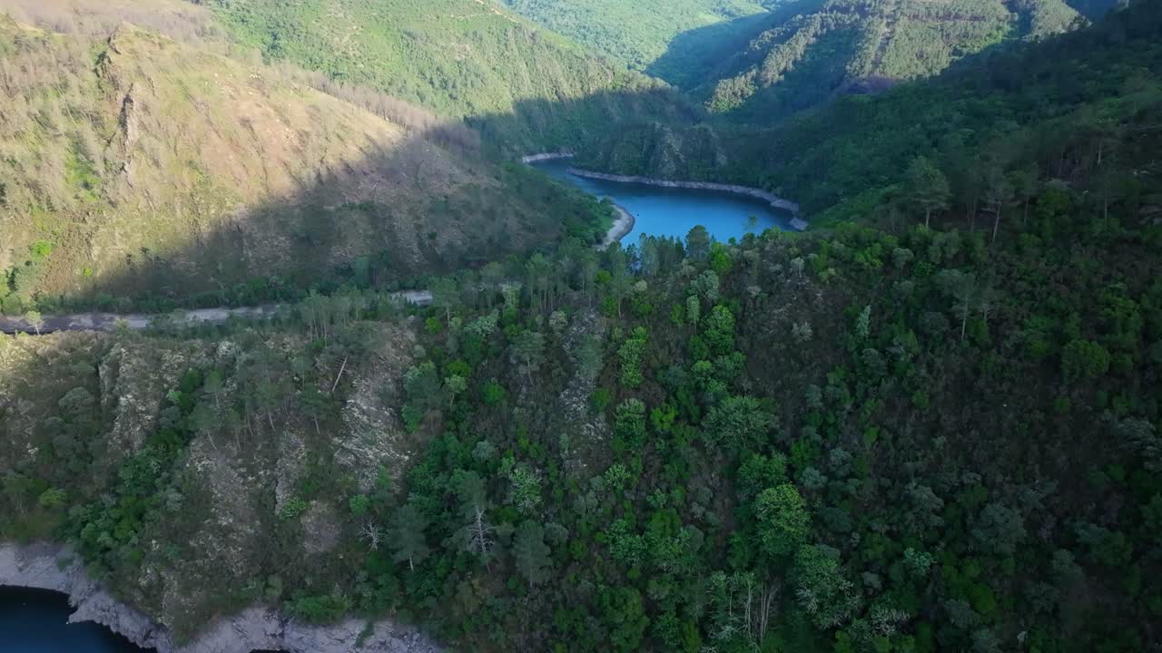 Aerial View of a Serene River Winding Through a Green Mountain Valley