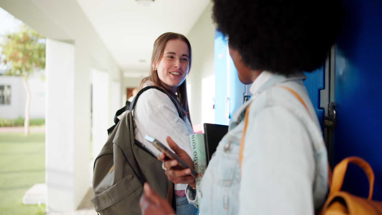 Two students chatting by school lockers