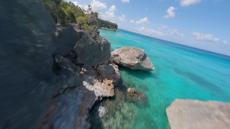 FPV-drone-flight-along-stunning-Caribbean-coastline,-crystal-clear-water