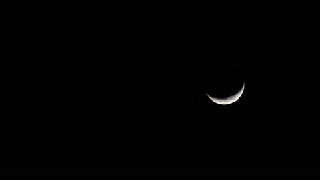 waxing crescent moon, 4k time lapse, descending moon from the top, going down to the right corner