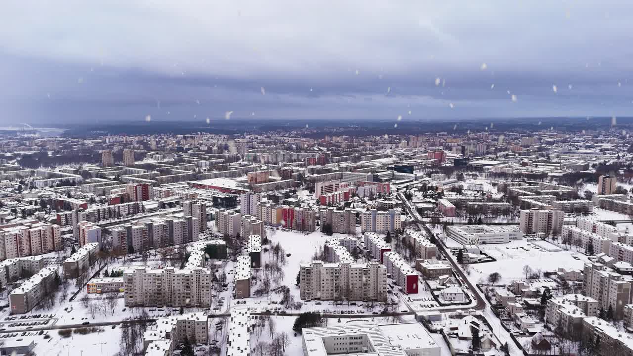 Kaunas city suburbs during snowfall, aerial panoramic view
