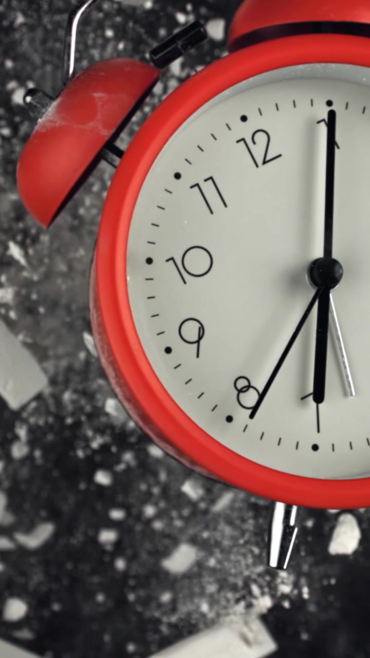 Close-up of Red Alarm Clock with Chalk on Dark Background