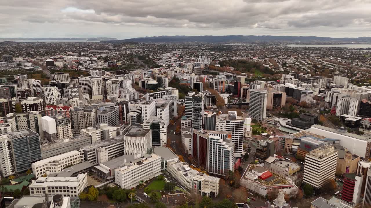 Auckland CBD, city buildings and architecture with Waitemata Harbour in background on overcast day, New Zealand. Aerial drone panoramic view