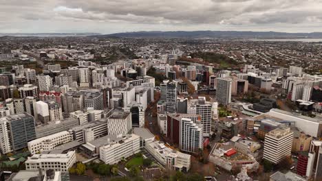 auckland cbd, city buildings and architecture with waitemata harbour in background on overcast day, new zealand. aerial drone panoramic view