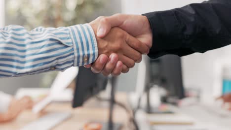 close-up of two male hands in the middle of a corporate office in the background, they are shaking hands firmly, greeting, saying goodbye, getting acquainted, congratulating, pride, joy