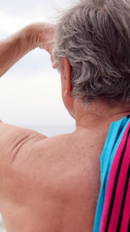 retired man looking away on the beach