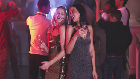 two-young-women-toasting-with-their-drinks