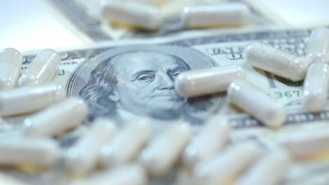 pharmaceutical business. white medical capsules on dollar banknote