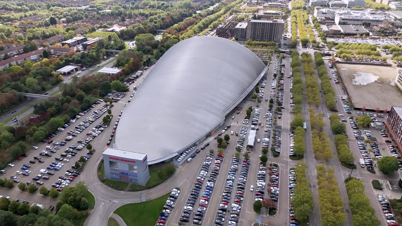 iFLY indoor skydiving aerial view circling futuristic polished silver shopping centre and car park