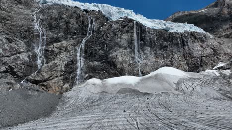 aerial forward drone closeup shot of fellaria's waterfalls and its glacier - valmalenco - sondrio