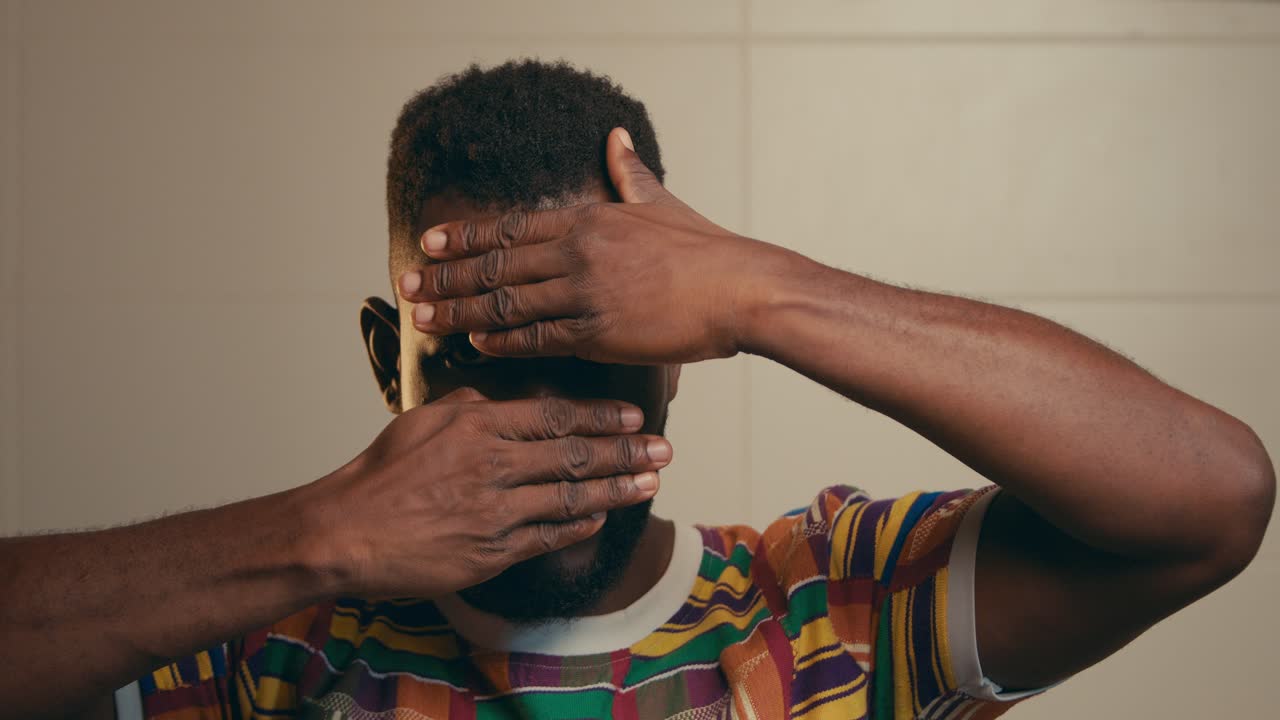 African American Man Slowly Hiding His Face With Two Hands