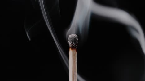 smoke swirling around a burned-out wooden matchstick