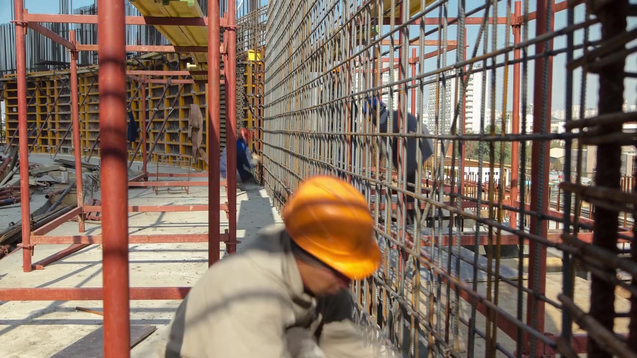 Construction workers working on steel rods used to reinforce concrete timelapse at sunny day