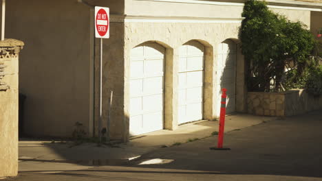 skateboarder riding out private household yard to los angeles street