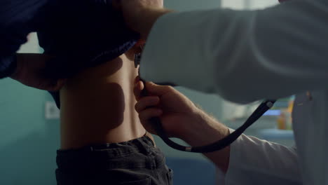 physician listening lungs teen girl using stethoscope at medical examination.