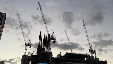cranes in perth - city skyline western australia - closeup silhouette at twilight