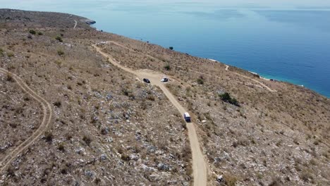 Aerial-view-of-a-van-driving-along-a-road-near-the-sea