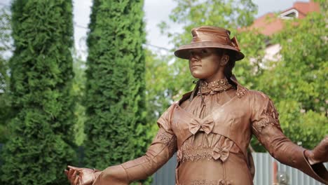 a living bronze statue performing outdoors