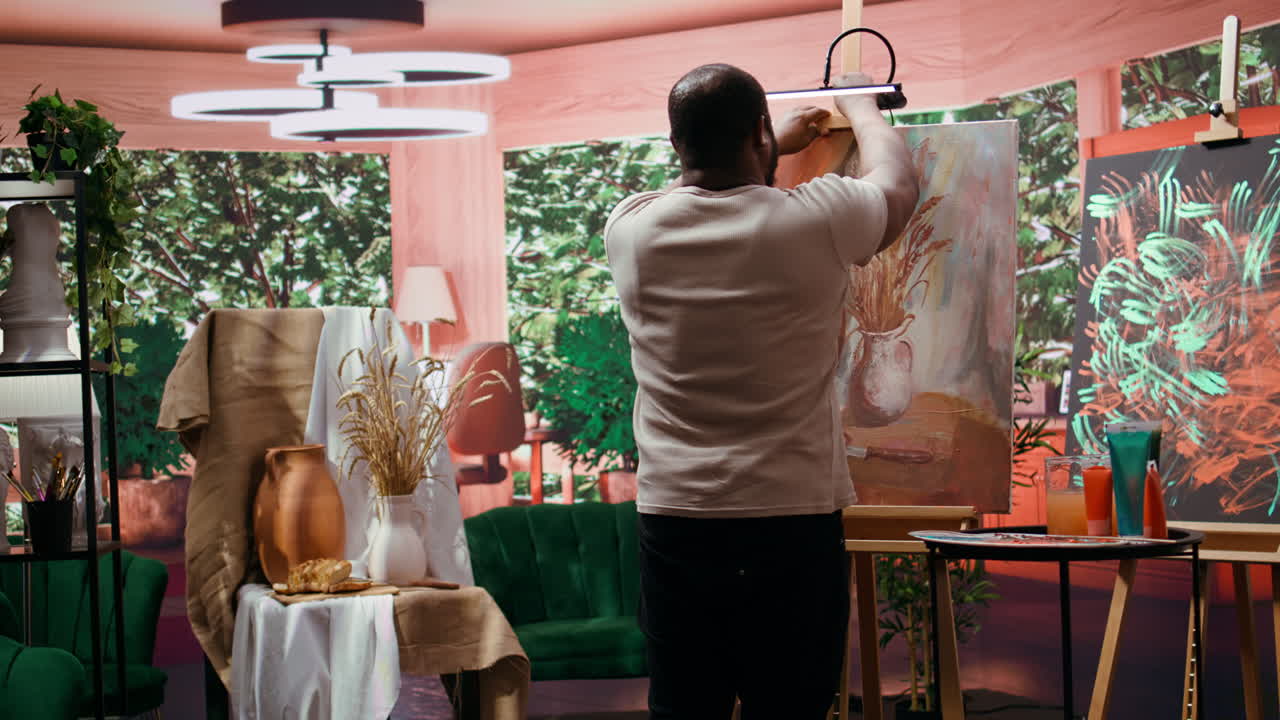 An artist painting a still life in their studio