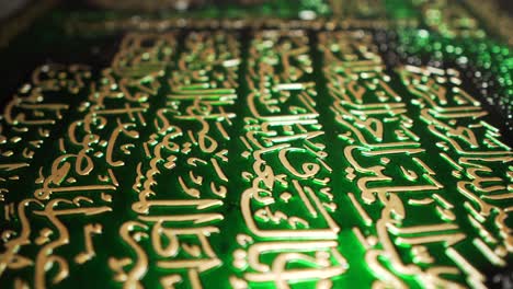 gold arabic writing on dark green placard decoration close up slider faith humanity culture observation