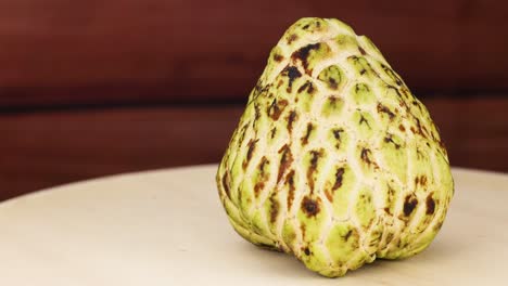 custard apple rotates on a wooden surface