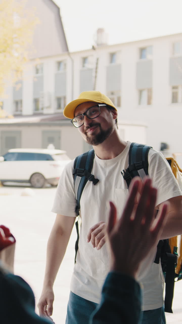 Delivery man waving hello with a smile