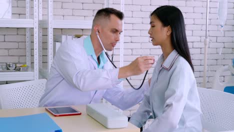 doctor in professional uniform examining patient at hospital