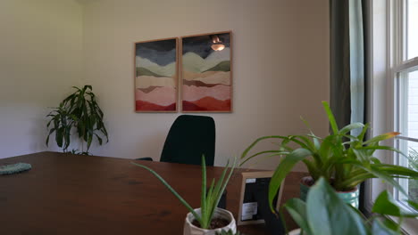 plants in home office on wooden desk for health, work life balance, work from home, orbiting cinematic shot