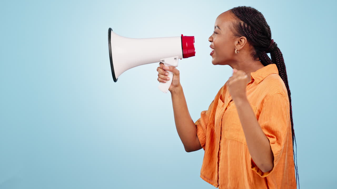 Woman, protest and shout with megaphone in studio