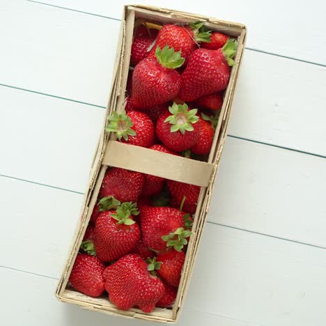 fresh healthy strawberries in a wooden box on white background