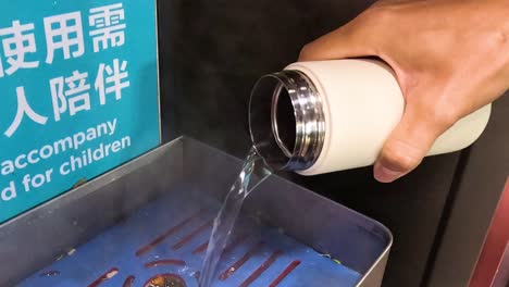 person pours hot water despite clear warning sign