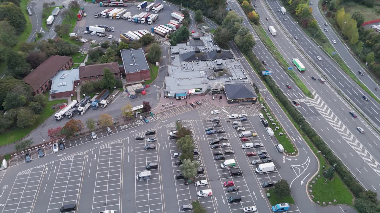 Aerial fly-in view of Gordano services showcasing entrance, main building complex and surrounding vehicle facilities, Bristol, UK, October 2024