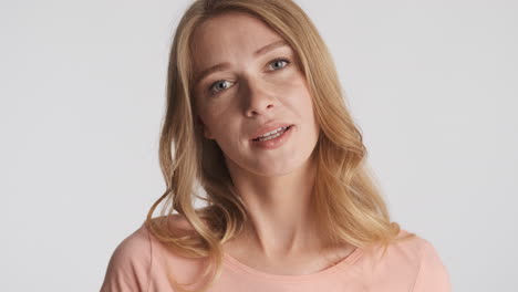 caucasian woman waving hands on camera.