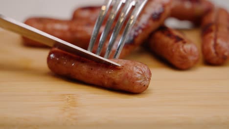 sharp knife slices through breakfast sausage in slow motion