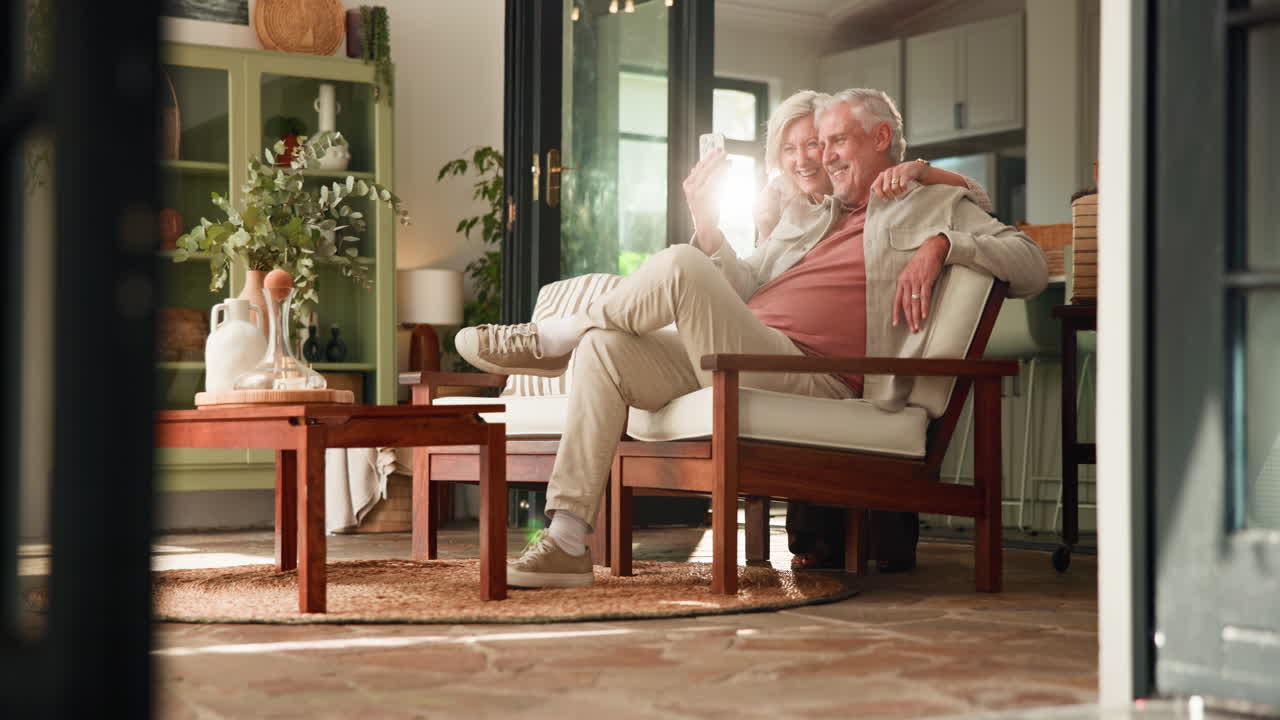 Happy Senior Couple Taking a Selfie Together in Their Living Room