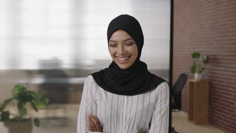 portrait of young muslim woman laughing cheerful arms crossed enjoying career opportunity in start up business