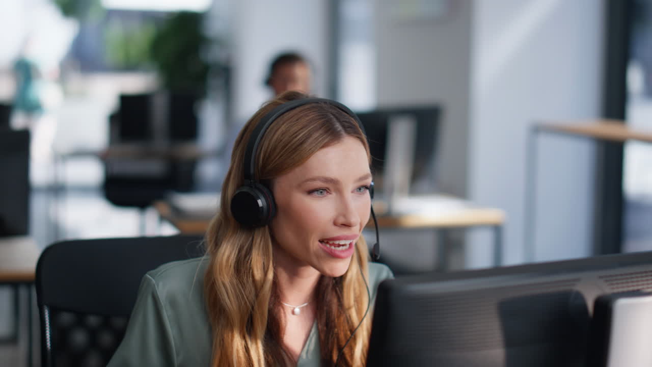 Woman providing customer service talking in headset at coworking space closeup