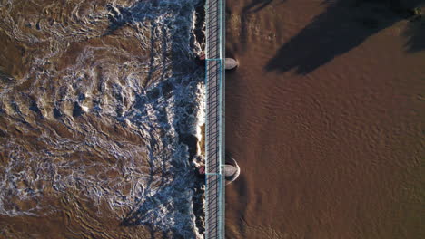 aerial view of a bridge over a rapid river