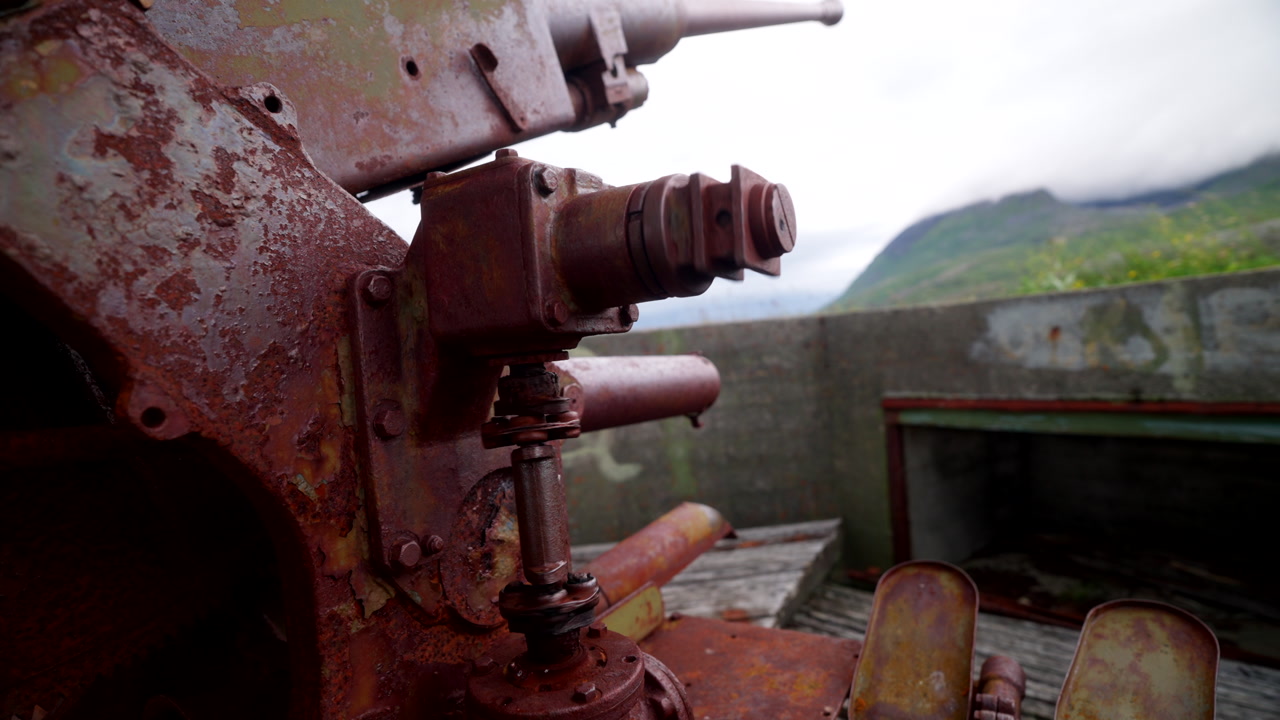 Mechanized spinning bolt details at abandoned Skrollsvik World War II fort ruins in Senja Norway, urban exploration establishing