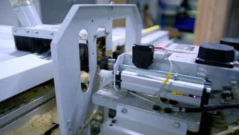 automated machine in workshop. manufacturing of doors. work of modern instrument. making furniture. close-up.