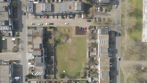 top down aerial of green park surrounded by suburban houses