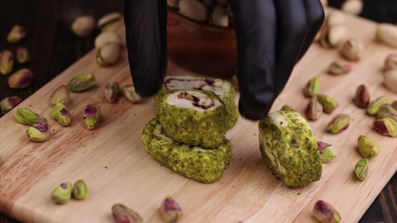 poner delicias turcas frescas con pistachos triturados y chocolate en una tabla