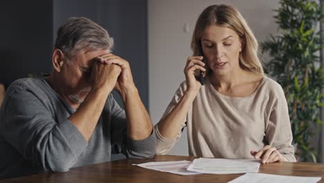 Caucasian-woman-helping-senior-man-with-using-mobile-phone.