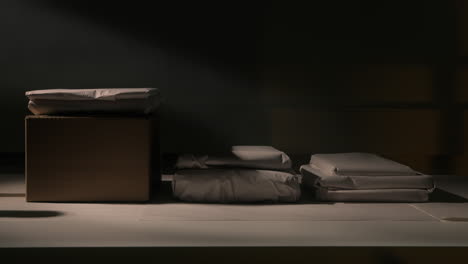 Old-Books-in-Paper-Wraps-Lying-on-Attic-Table-with-Moody-Lighting