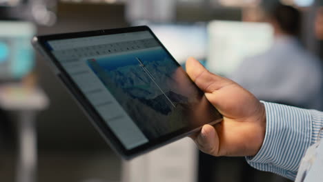 close up of employee doing digital modeling of wind energy generator gear