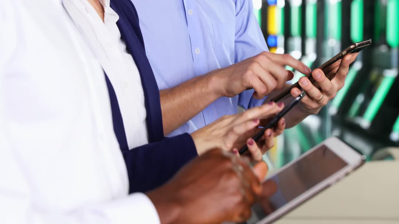 Business colleagues using electric gadgets 4k