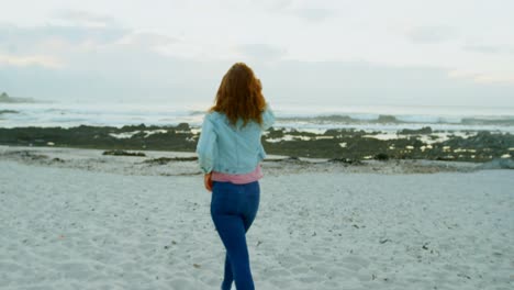 Woman-walking-on-beach-at-dusk-4k