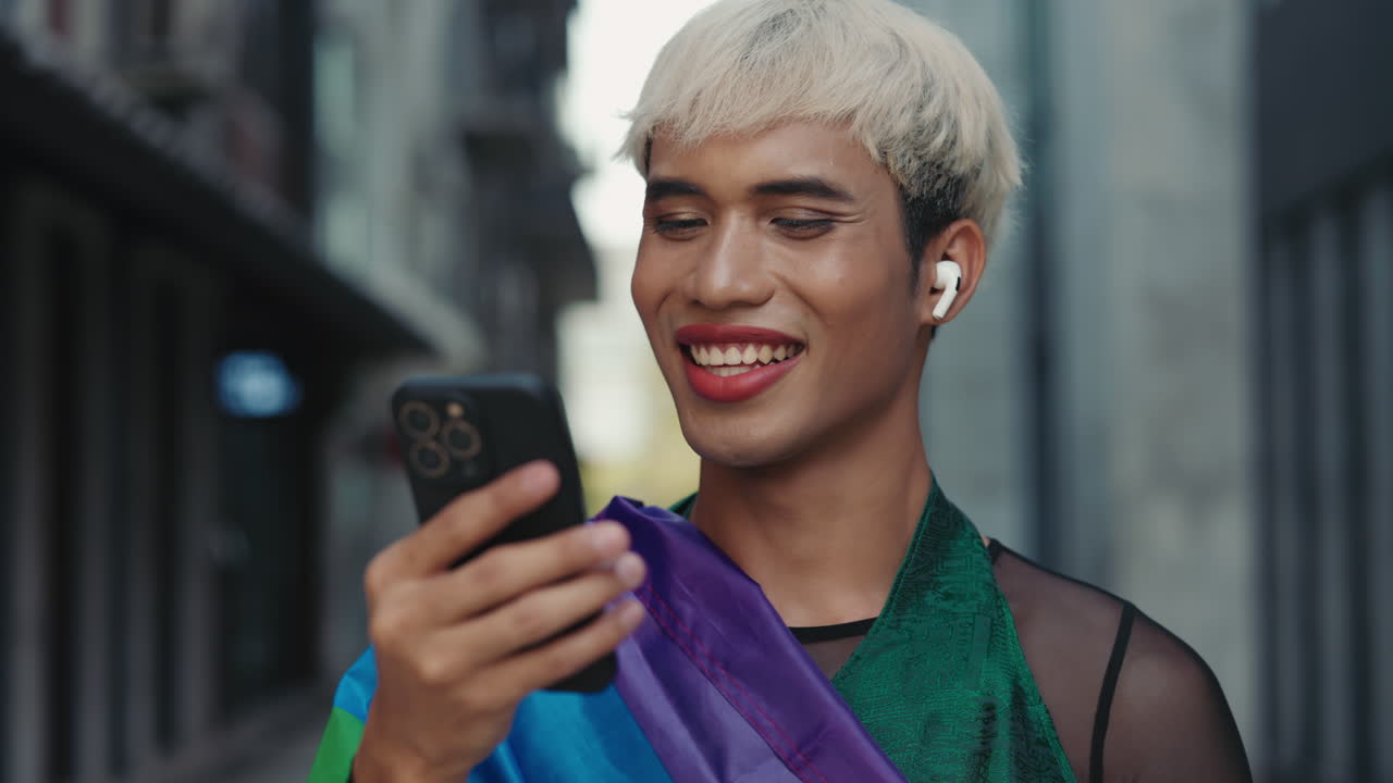 Happy Person Using Smartphone on the Street