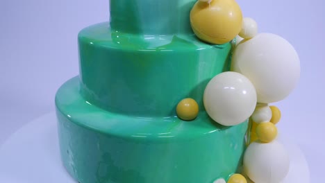 modern green glazed cake with sphere decorations